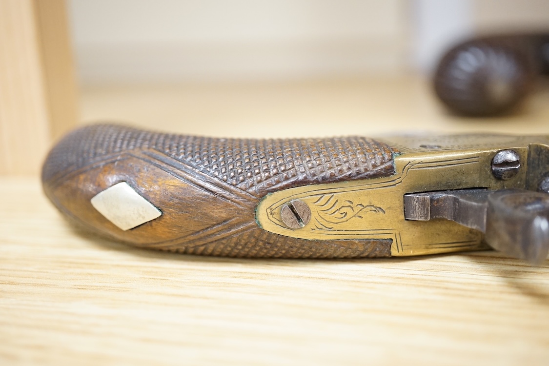 A boxlock percussion pocket pistol with turn off barrel, Birmingham proofs, engraved brass frame, and chequered rounded walnut grip